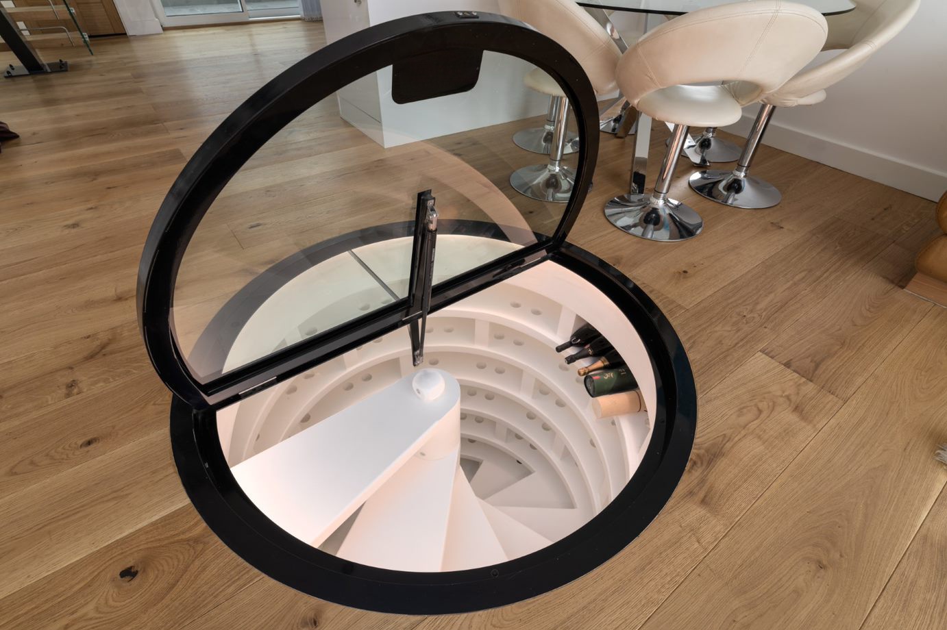 spiral wine cellar door hatch lid in glass over circular opening
